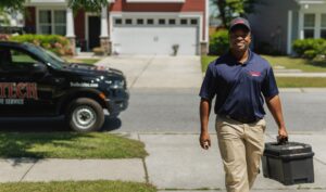 Trutech technician approaching a home with their toolbox in hand